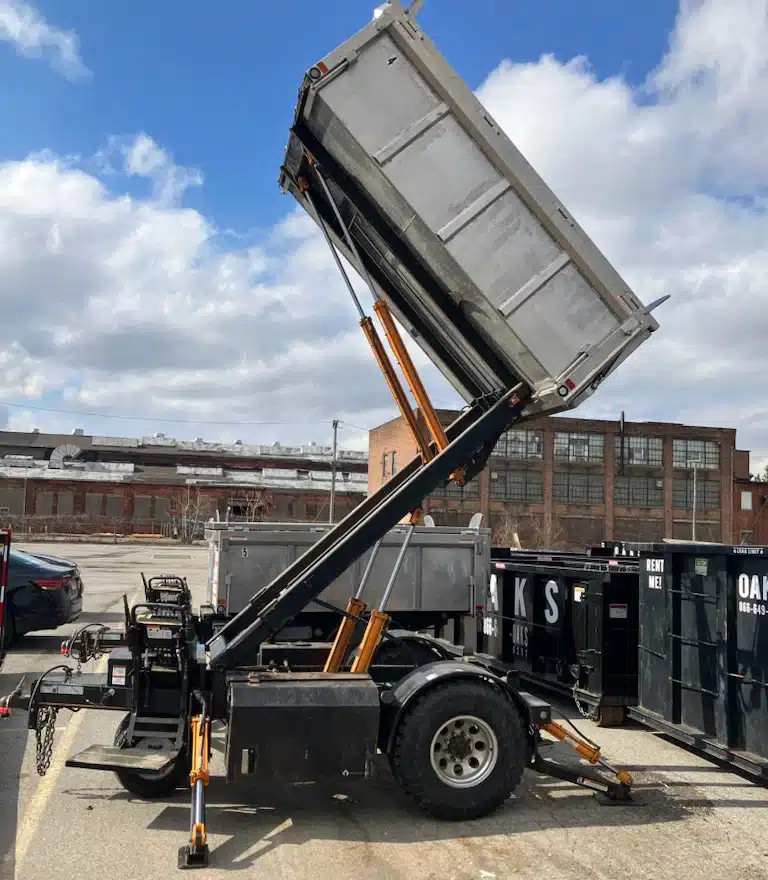 a dump trailer with its bed tilted up