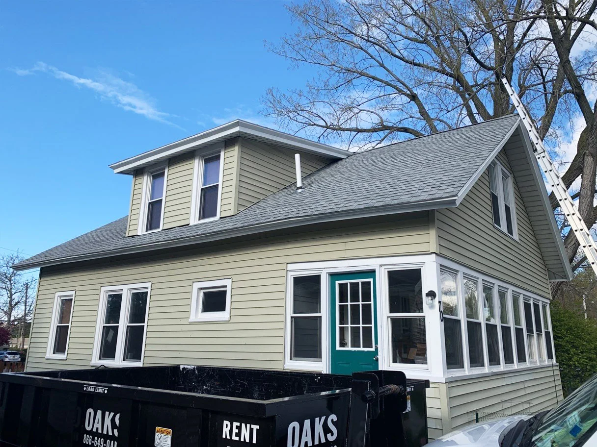 house with construction dumpster