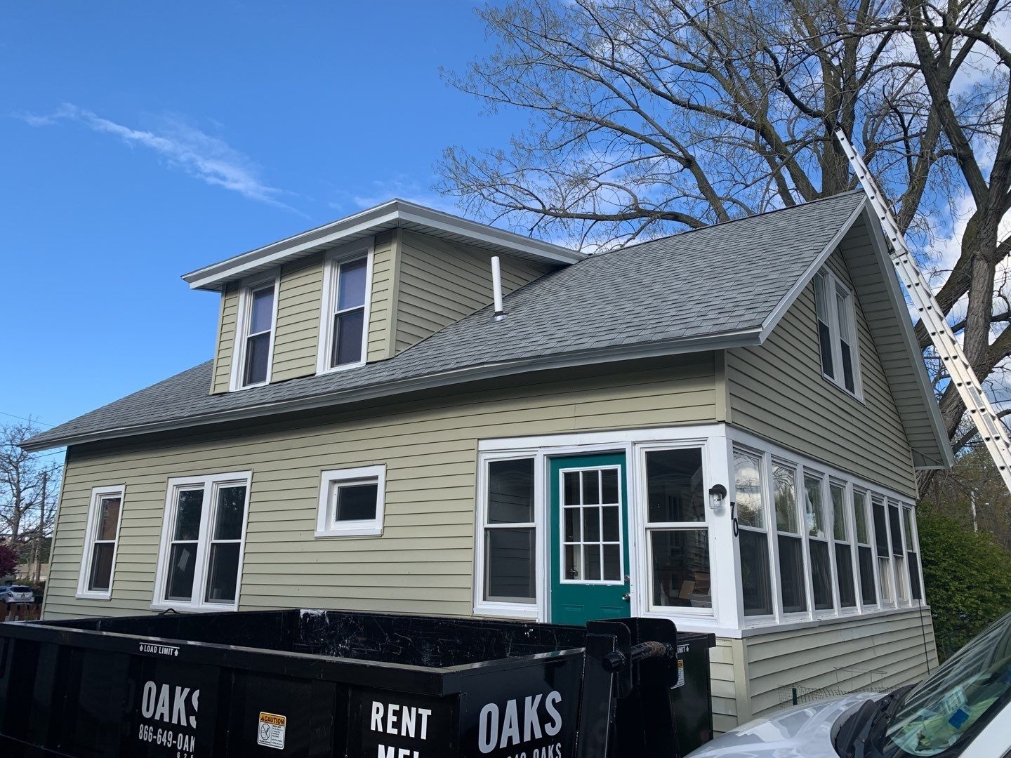 A house with a green door and white trim