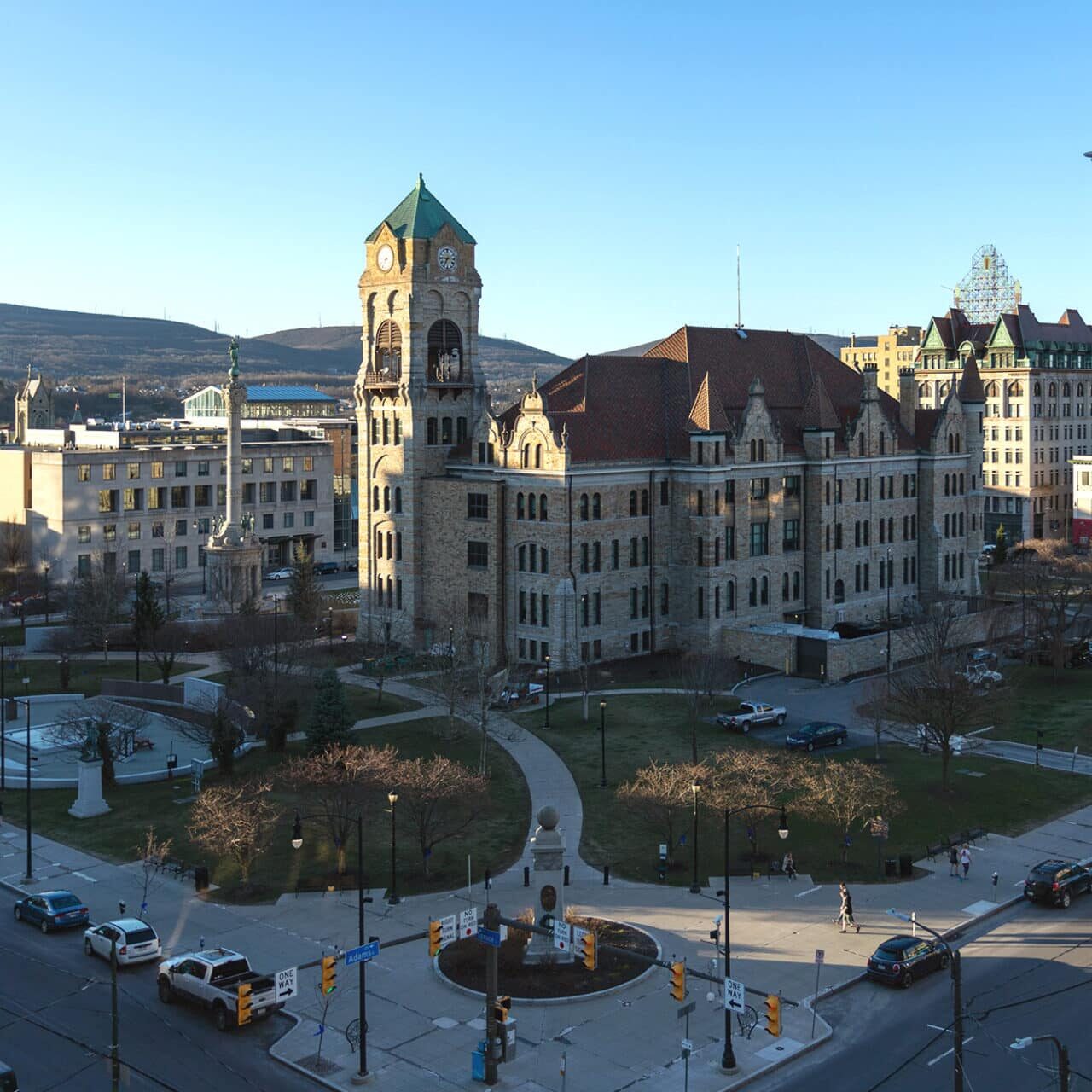 A city street with historic buildings and a park