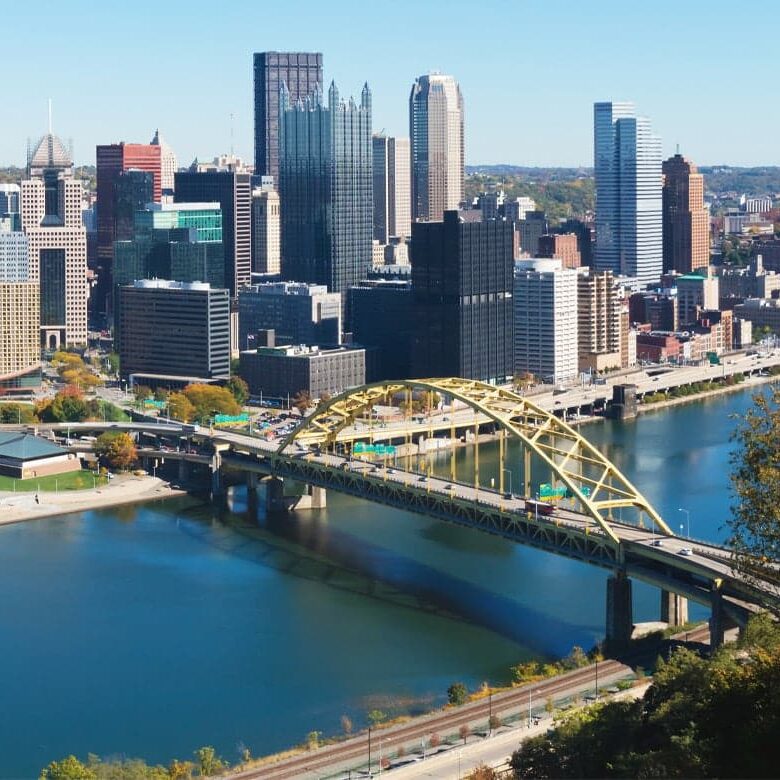 Pittsburgh cityscape with a yellow bridge over a river